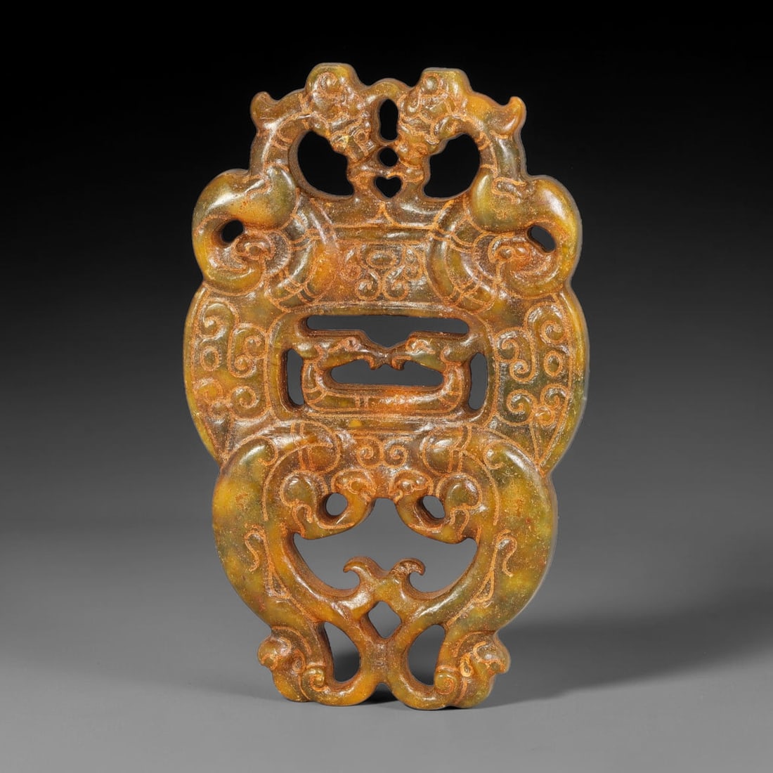 A Chinese Openwork Mottled Jade Multi-Dragon Pendant, 33BD (1 of 2)