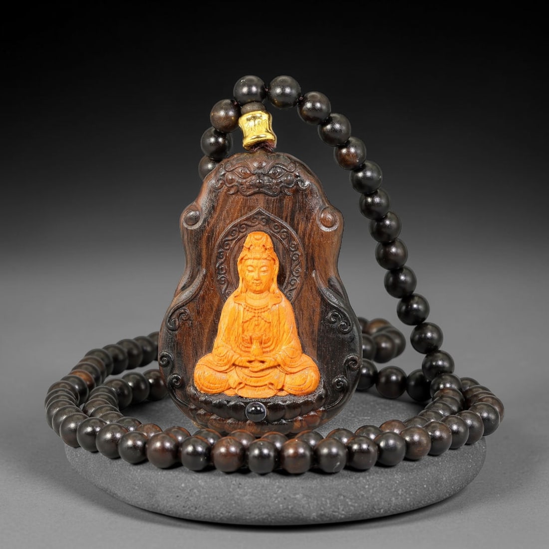 A Chinese Carved Wood Gourd Form Pendant with Inlaid Guanyin and Beaded Necklace, 83BD: Gourd-shaped carved wood pendant with relief carved beast mask at the upper section and scrolling decorative borders. The central panel features an inlaid seated Guanyin figure holding a vessel upon a