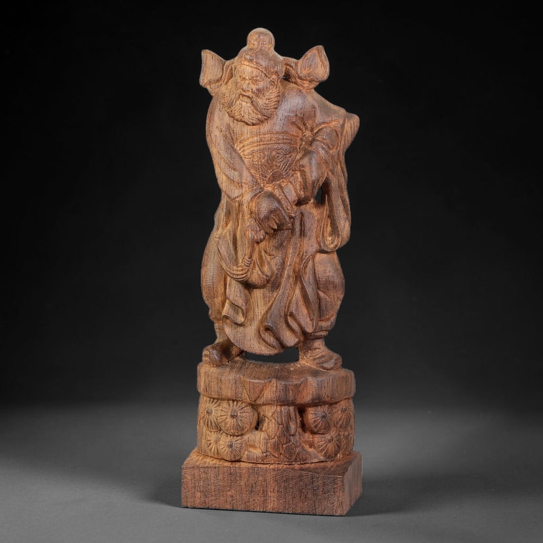 A Chinese Agarwood Carved Zhong Kui Sculpture, 79BD: Finely carved agarwood figure of Zhong Kui standing upon a decorated two-tiered base with floral relief ornamentation. The sculpture captures the traditional fierce facial expression, full beard and f