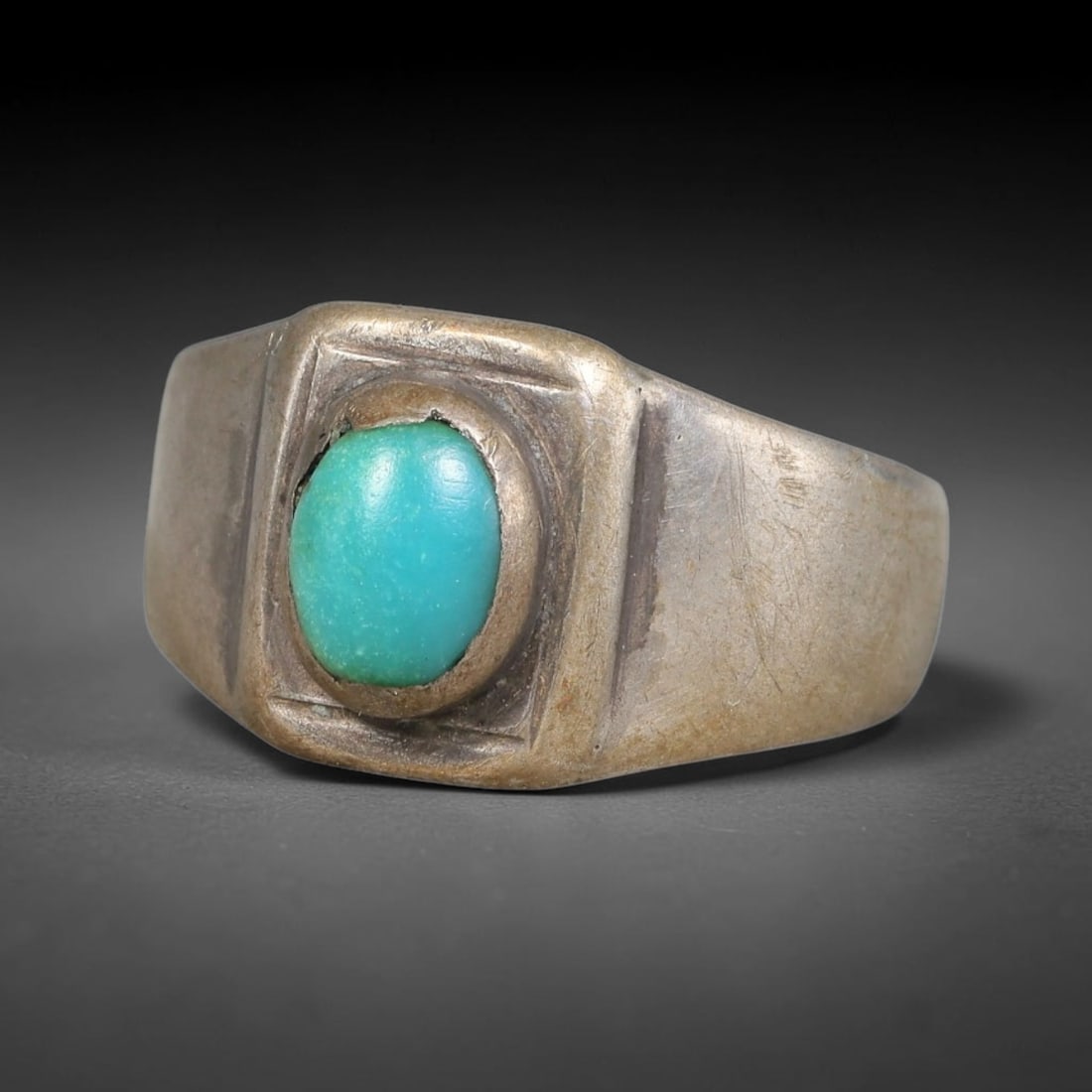Antique Ottoman Turquoise Rectangular Framed Bezel Silver Ring, 28AL: Silver ring of the Ottoman period set with an oval cabochon turquoise, enclosed within a raised rectangular framed bezel. The wide solid band bears subtle surface wear from age. No hallmarks present. 