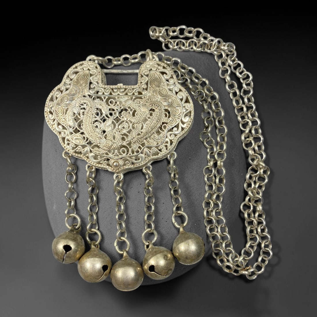 A Chinese Filigree German Silver Dragon Phoenix Lock Pendant Necklace, 91BD: Filigree German silver ruyi-shaped lock pendant, one side featuring openwork dragon and phoenix motifs, the reverse finely decorated with large floral and butterfly ornamentation. Five hanging chains 