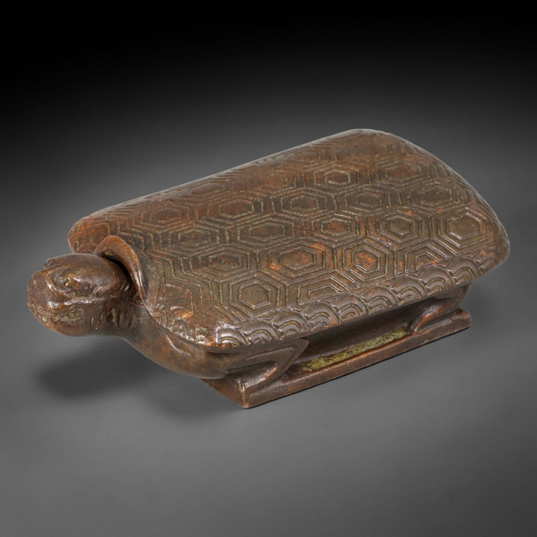 A Chinese Antique Bronze Turtle Form Lidded Box, 2BT: This bronze vessel is modelled in the form of a turtle with a detachable shell lid. The turtle shell is finely decorated with repeating hexagonal scale patterns, and the creature rests on a rectangula
