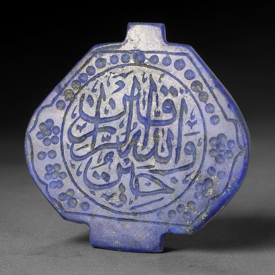 Antique Mughal Style Lapis Lazuli Islamic Calligraphic Script Talisman Plaque, 40BE: A fine Mughal style talisman plaque carved from lapis lazuli, adorned with intricate Islamic calligraphic script covering the main face. The plaque is cut with a small suspension lug at the top, desig