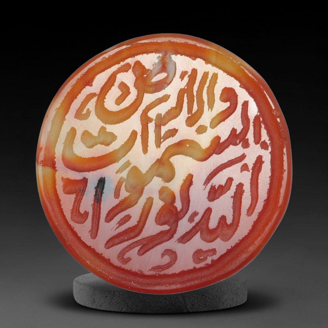 Antique Mughal Style Carnelian Islamic Calligraphic Script Talisman Plaque, 28BL: This talisman plaque is crafted from carnelian, deeply engraved with flowing Islamic calligraphic script across its face, enclosed within a fine engraved border. The meticulous carving captures elegan