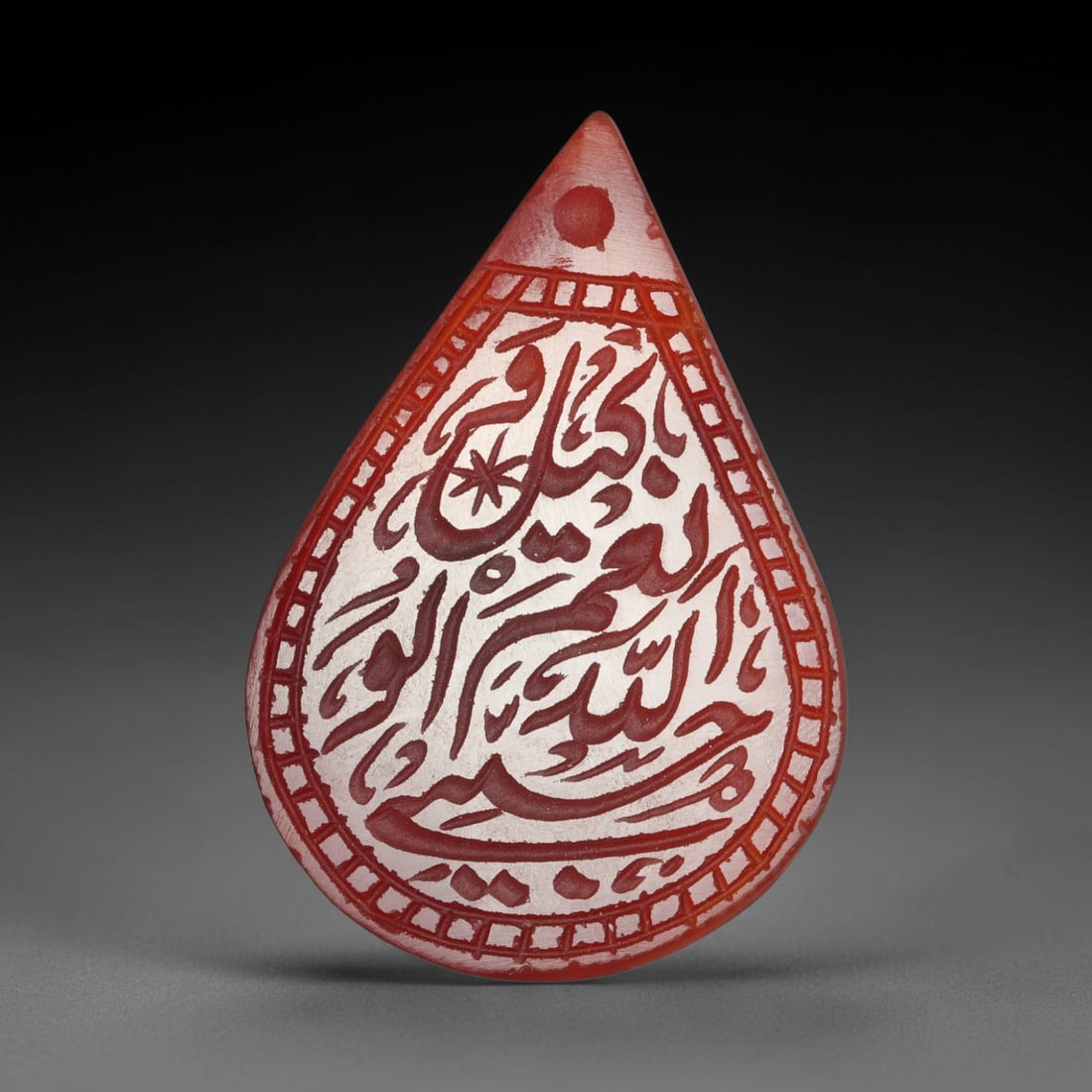 Antique Mughal Style Carnelian Islamic Calligraphic Script Talisman Plaque, 64BL: This talisman plaque is crafted from carnelian, deeply engraved with flowing Islamic calligraphic script across its face, enclosed within a fine engraved border. The meticulous carving captures elegan