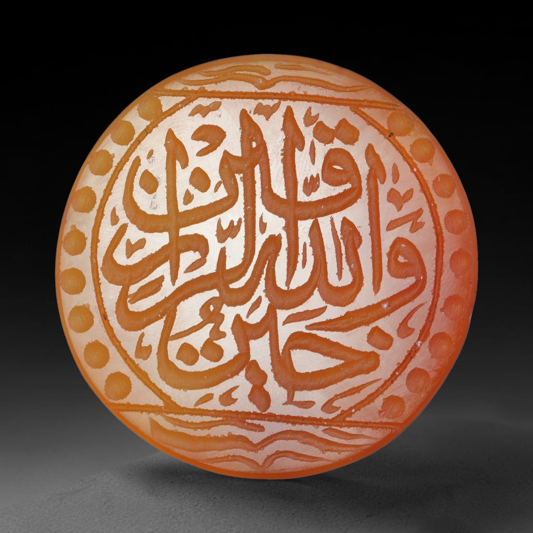 Antique Mughal Style Carnelian Islamic Calligraphic Script Talisman Plaque, 49BL: This talisman plaque is crafted from carnelian, deeply engraved with flowing Islamic calligraphic script across its face, enclosed within a fine engraved border. The meticulous carving captures elegan