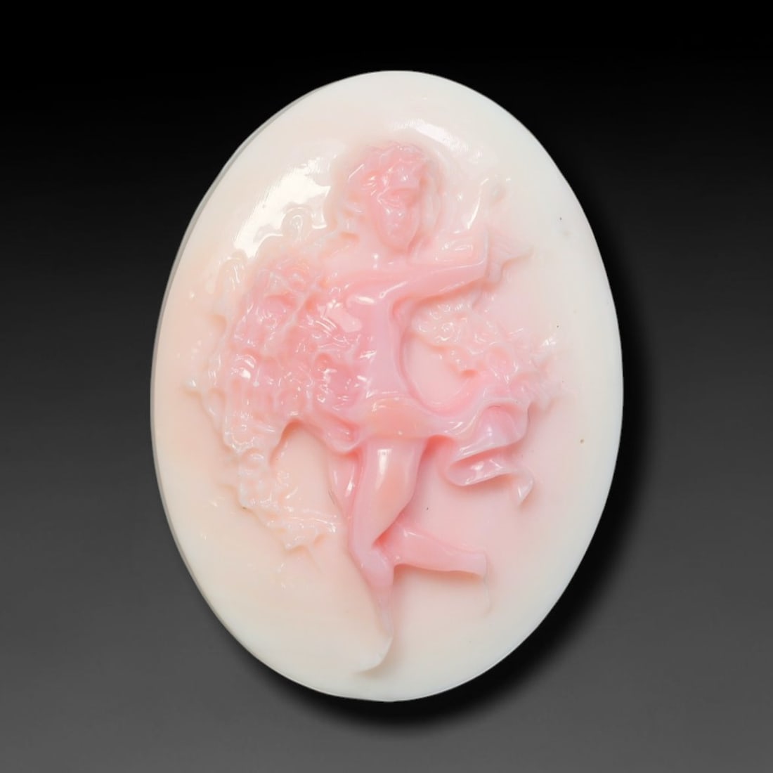 Natural Pink Queen Conch Shell Winged Cherub Relief Carved Intaglio Bead, 76BP: Expertly carved natural pink Queen Conch shell intaglio bead featuring fine relief carving of a winged cherub in dynamic pose, accented with swirling ribbon and decorative foliage details. The shell s