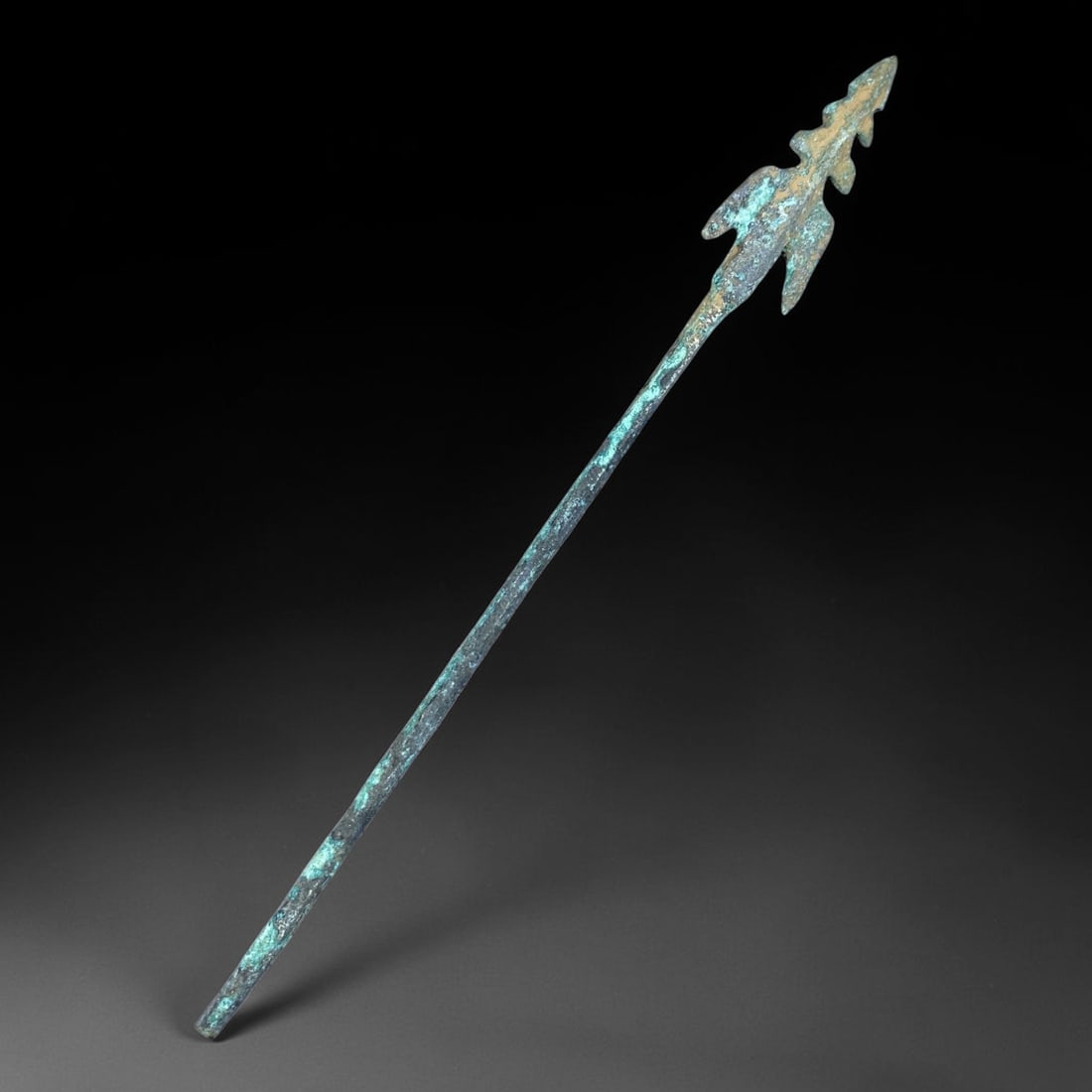 Ancient Chinese Bronze Spearhead, 6BP: Ancient Chinese bronze spearhead, featuring a multi-barbed pointed tip attached to a long slender shaft. The surface is covered with authentic burial patina, marked by blue-green copper encrustations 