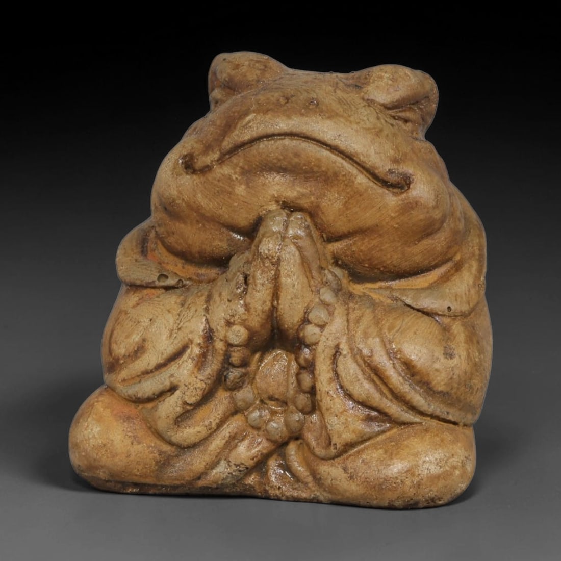 A Chinese Stone Figurine of Praying Frog with Prayer Beads, 97BL: Hand-carved from stone, this charming figurine depicts a frog seated in meditative pose with hands clasped together in prayer, draped in robes and holding a strand of prayer beads. The surface bears n