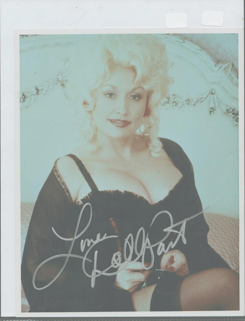 Dolly Parton - Signed 8 x 10 photograph: Dolly Parton - Signed 8 x 10 photograph. A signed 8 x 10 color glossy photograph signed by Dolly Parton. Comes with a COA from Todd Mueller Autographs