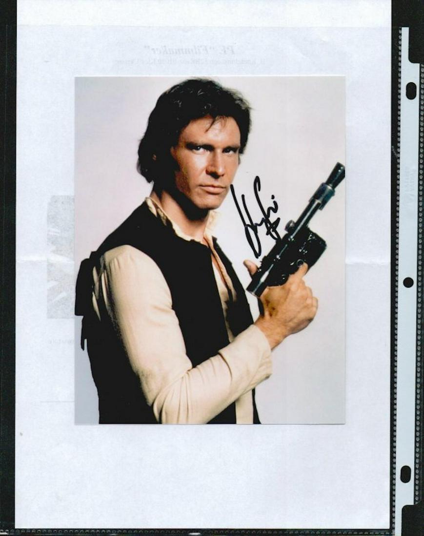 HARRISON FORD (HAN SOLO) SIGNED 5 X 8 PHOTOGRAPH. THIS: HARRISON FORD (HAN SOLO) SIGNED 5 X 8 PHOTOGRAPH. THIS PHOTO WAS HAND SIGNED IN KIEVE, UKRAINE BY HARRISON FORD AT THE PREMIERE OF "ENDER'S GAME." IT WAS HAND SIGNED WITH A BLACK MARKER