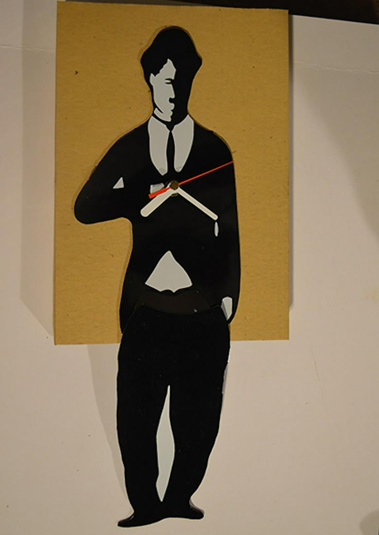 CHARLIE CHAPLIN WALL CLOCK: CHARLIE CHAPLIN WALL CLOCK. MEASURES AT 16 INCHES. NEVER USED