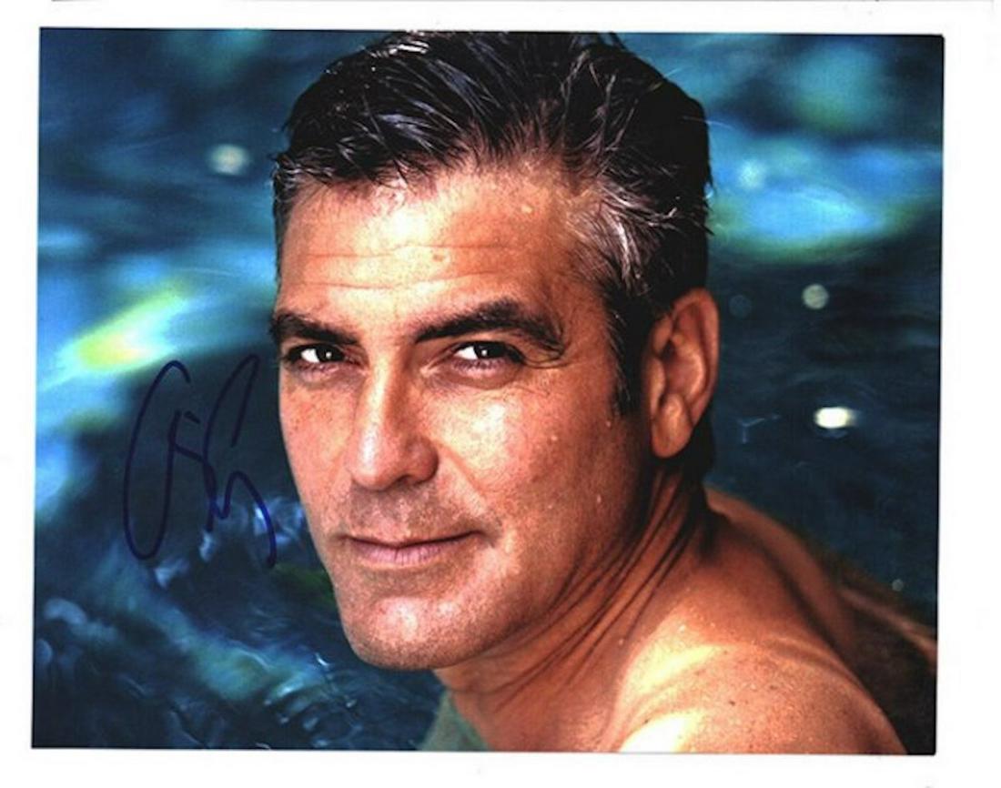 GEORGE CLOONEY SIGNED 8 X 10 PHOTOGRAPH: GEORGE CLOONEY SIGNED 8 X 10 COLOR SATIN FINISH PHOTOGRAPH. SIGNED BY GEORGE CLOONEY IN BLUE FELT TIP INK. CERTIFICATE OF AUTHENTICITY IS GUARANTEED BY TODD MUELLER AUTOGRAPHS