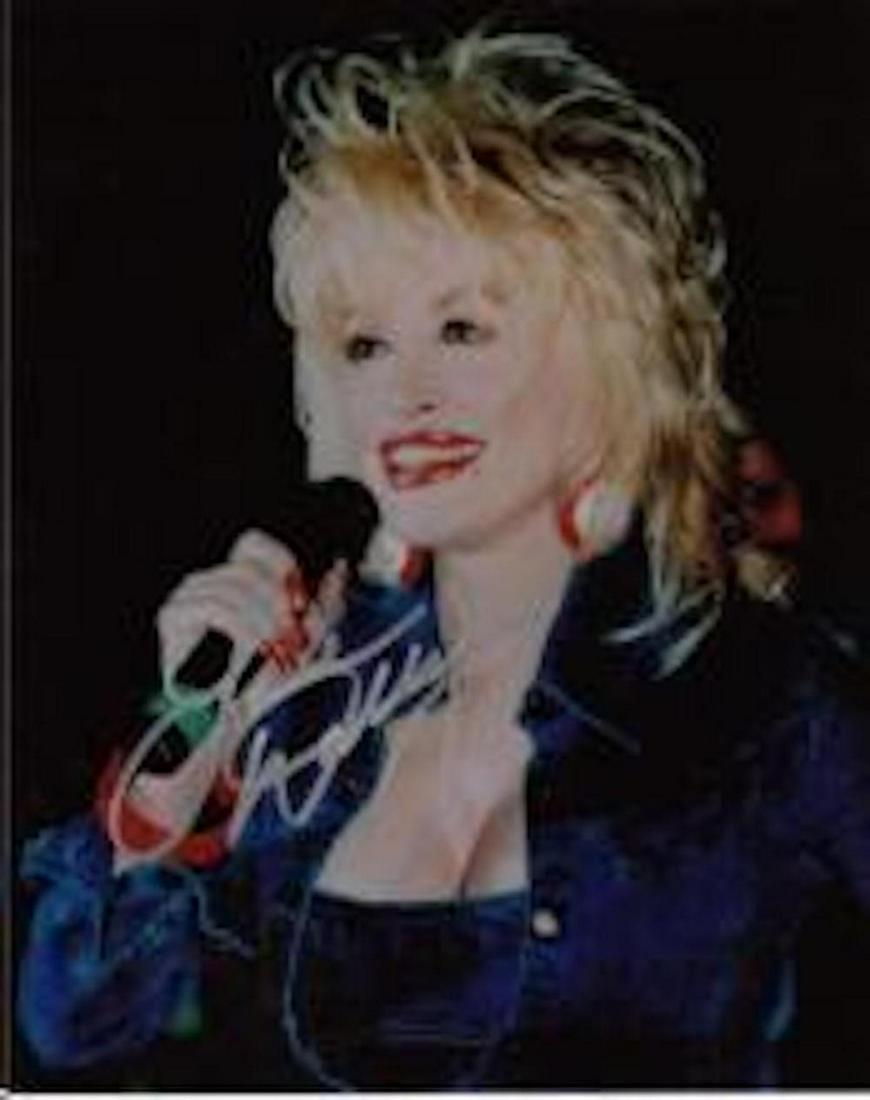 DOLLY PARTON SIGNED 8 X 10 PHOTOGRAPH: DOLLY PARTON SIGNED 8 X 10 PHOTOGRAPH. THE CERTIFICATE OF AUTHENTICITY OF THIS ITEM IS GUARANTEED BY ENCORE AUTOGRAPHS. THIS ITEM HAS BEEN INSPECTED AND IS DETERMINED TO BE AUTHENTIC AND WAS SIGNED IN