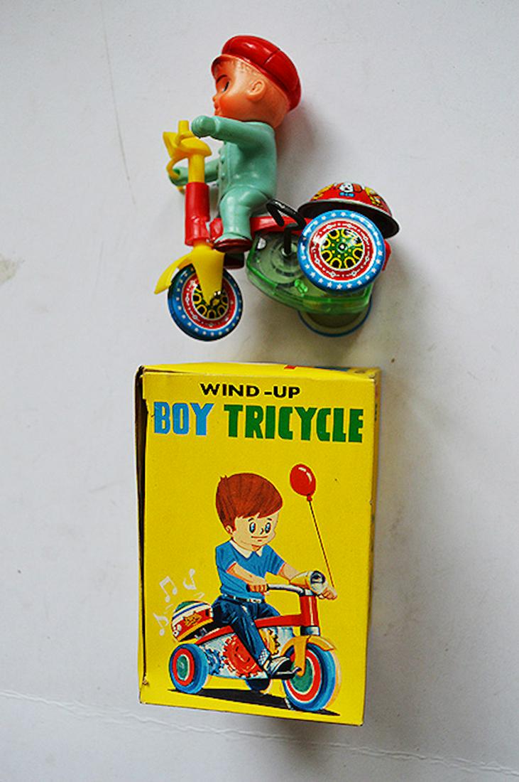 WIND-UP BOY TRICYCLE TOY: WIND-UP BOY TRICYCLE TOY. MEASURES AT 4 INCHES. NEVER USED