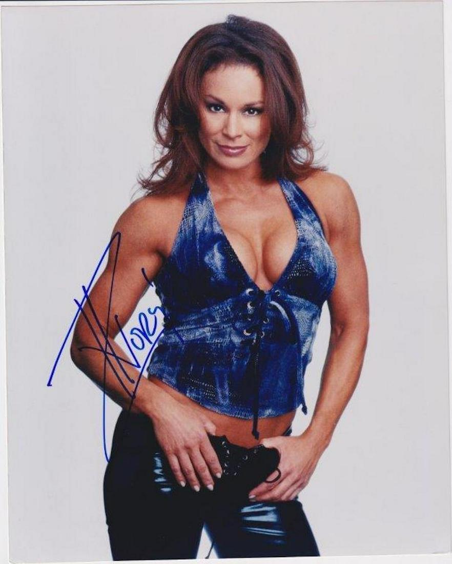 Ivory - 8 x 10 Signed Photograph w/COA: Ivory - 8 x 10 Signed Photograph w/COA. Color glossy photograph signed in blue felt tip ink professional wrestler Ivory. In good condition.