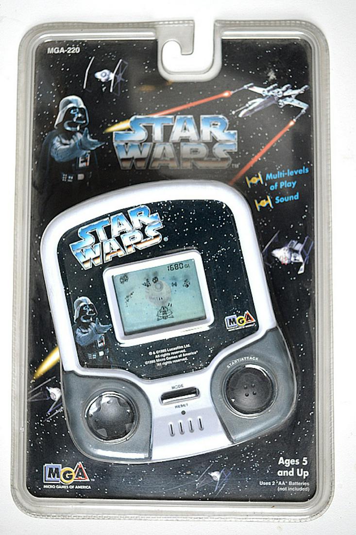 CLASSIC STAR WARS HANDHELD GAME: CLASSIC STAR WARS HANDHELD GAME. FROM 1995. MEASURES AT 5.5 INCHES. NEVER USED