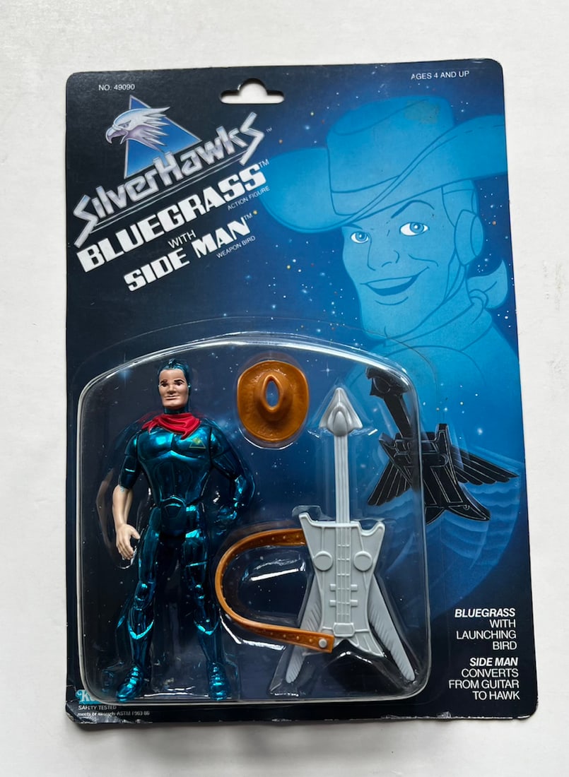 Silver Hawks - Bluegrass w/ Side Man Action Figure On Card: Silver Hawks - Bluegrass w/ Side Man Action Figure On Card. The card is punched on the top. The plastic enclosure is intact. New and unused