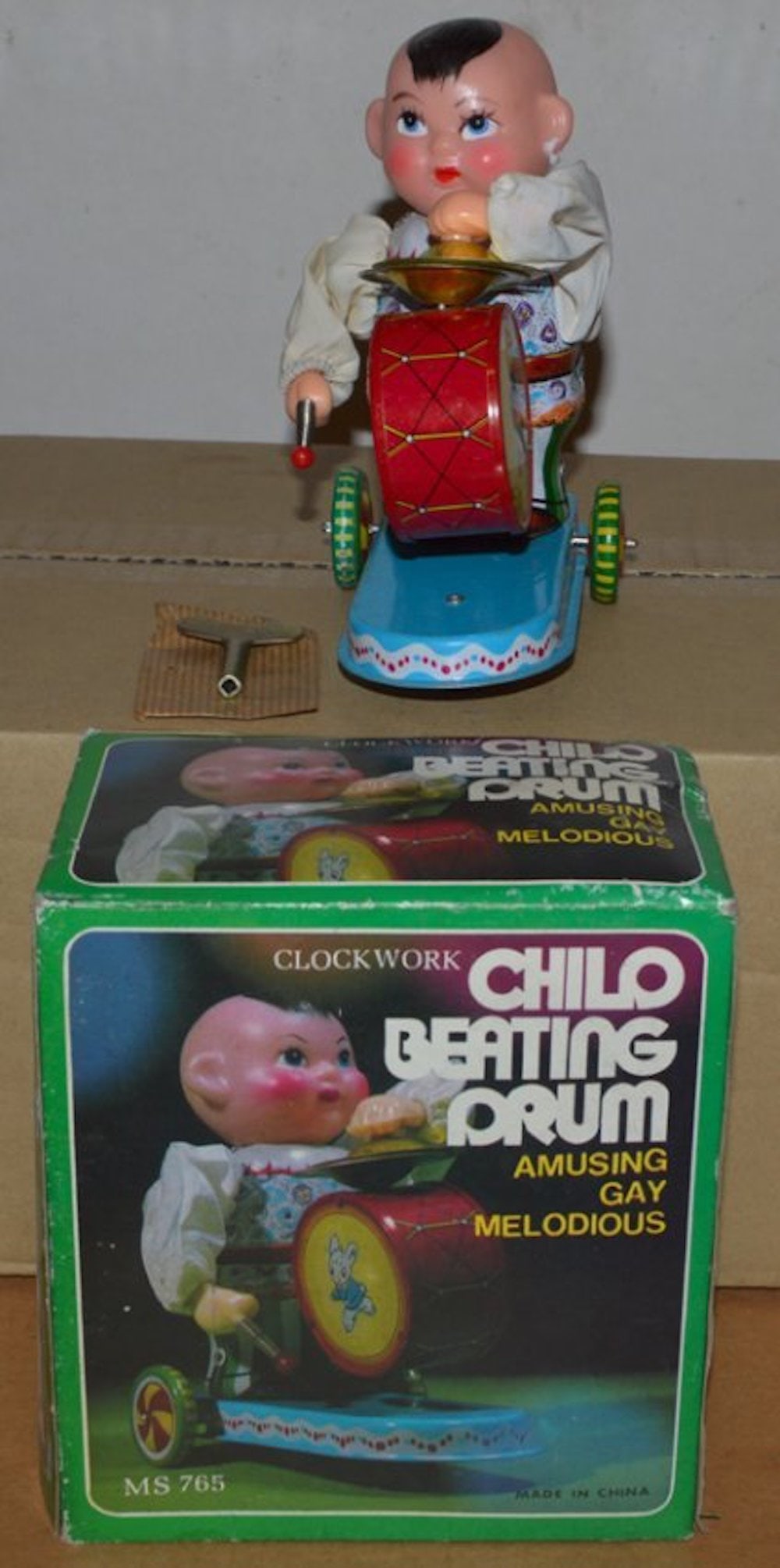 CLOCK WORK CHILD BEATING DRUM FIGURE: CLOCK WORK CHILD BEATING DRUM FIGURE. AMUSING FUN MELODIES. MADE IN CHINAMINT IN BOX. COMPLETE AND INTACT.