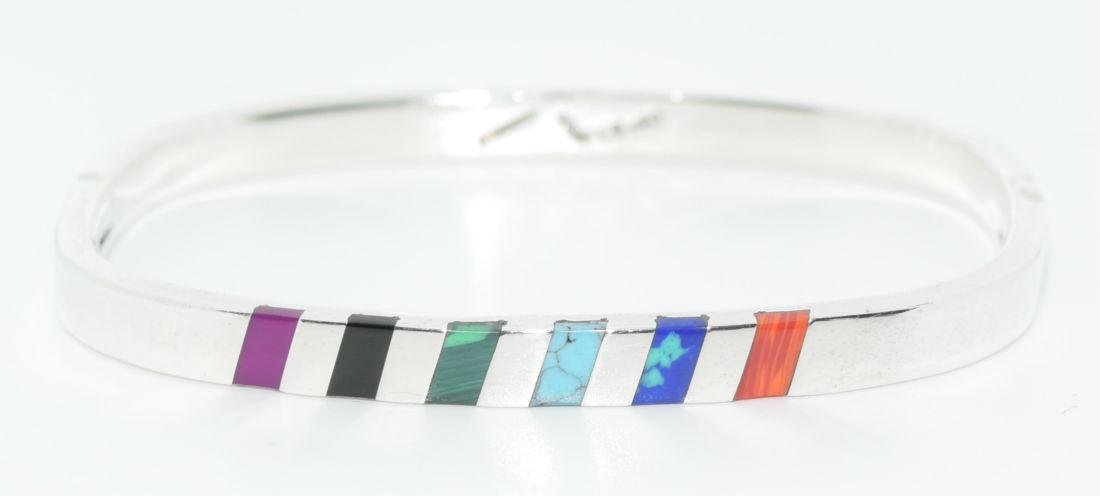 Vintage Mexico Sterling Silver Inlayed Bracelet: This piece weighs 25.2 grams with 6 carefully set stones to include coral, azurite, turquoise, malachite, jet, and sugilite. The bracelet measures 2.40" by 1.90" on the inside . Is 5.5mm by 2.5mm thic