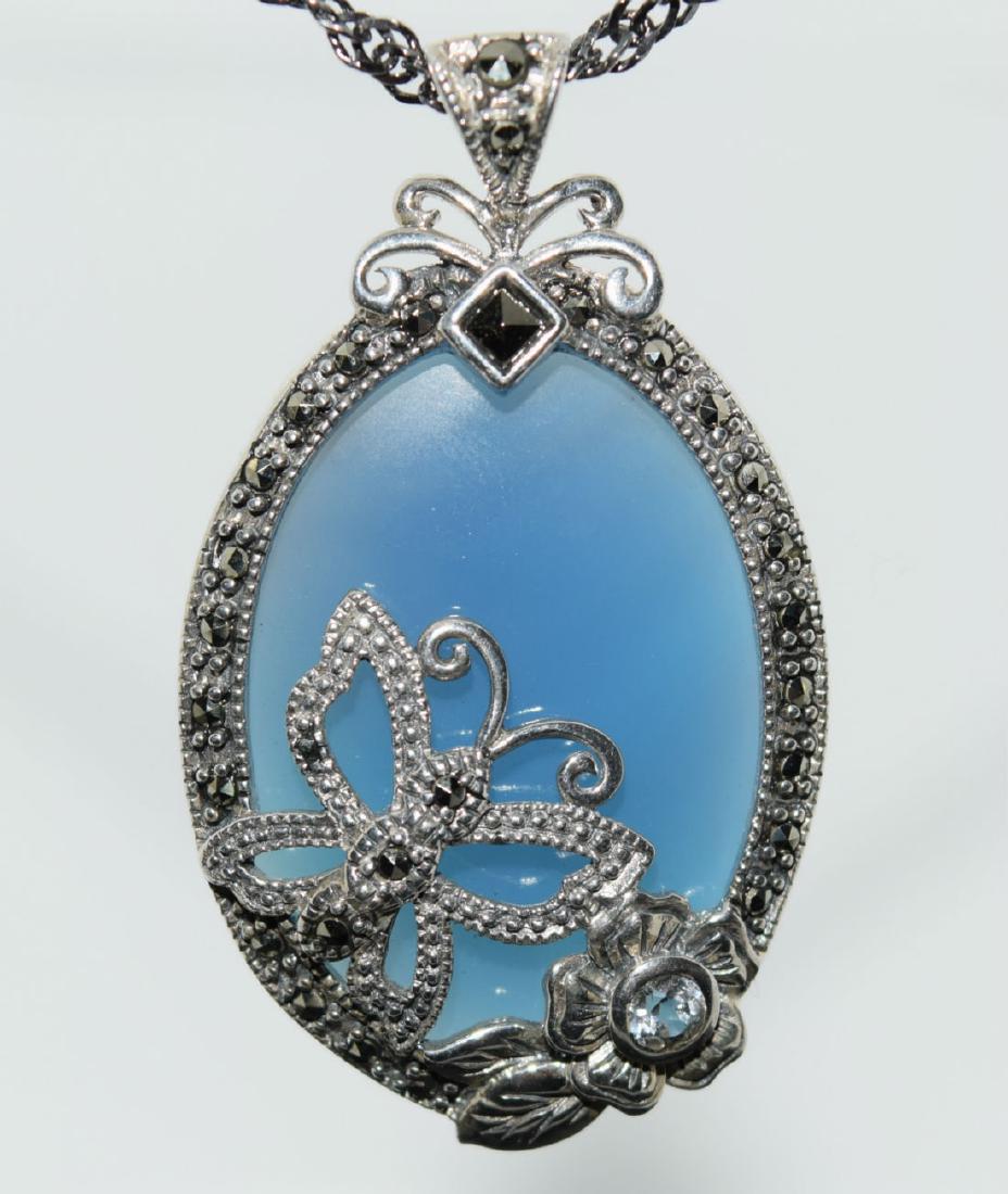 Sterling Silver Tourmaline, Topaz, Marcasite Necklace: Sterling silver blue tourmaline, white topaz, and marcasite butterfly and flower oval pendant and oxidized Singapore chain necklace. | Measurement: 24” long 2mm thick, 1.6” pendant drop 1” wide|