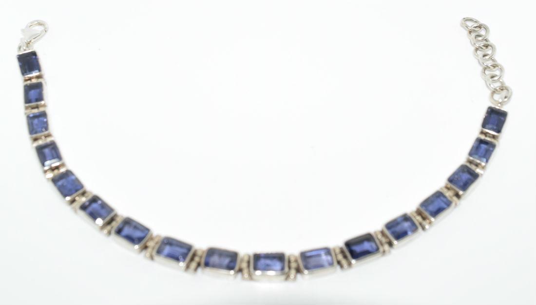 Sterling Silver Tanzanite Tennis Bracelet: Sterling silver tanzanite tennis bracelet. Tanzanite helps you speak the truth in your heart. | Measurement: 7.5” â€“ 9” long 6mm wide | Weight: 15.6 grams | Stamp: 925