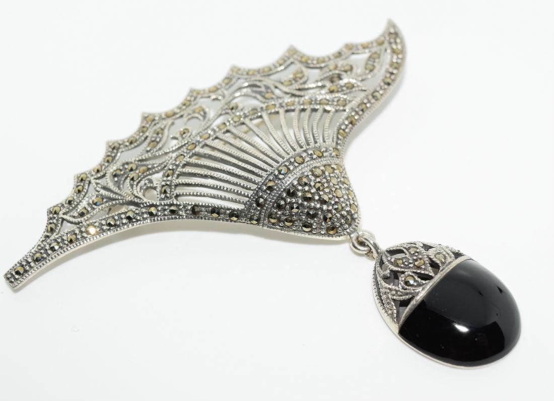 Sterling Silver Marcasite & Onyx Brooch: Sterling silver marcasite and onyx brooch | Measurement: 3" height x 3.2" width | Weight: 18.3 grams | Stamp: A 925