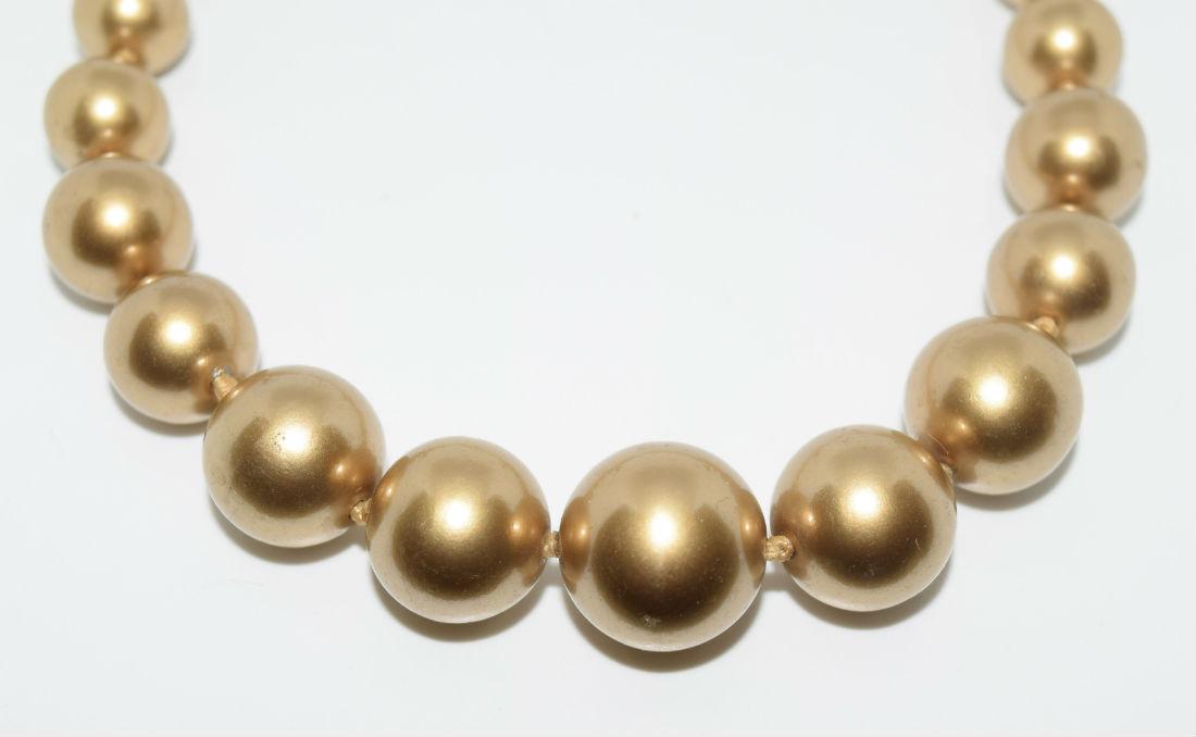 Monet Gold Graduated Knotted Bead Necklace: Monet gold graduated knotted bead necklace with toggle clasp | Measurement: 17" - 19" length 7mm - 17mm beads