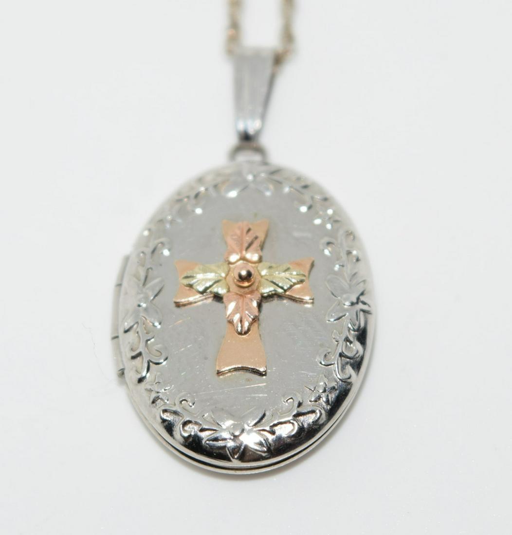 Sterling Silver & 10K Gold Cross Locket Necklace: Sterling silver and 10K gold cross locket pendant necklace. Inside the locket is engraved "May the light of the Lord shine upon you" | Measurement: 20" length, 1.1" pendant drop 0.6" width