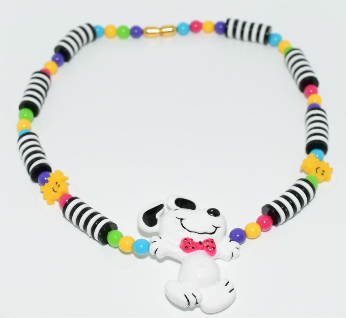 Vintage 1960's Snoopy Costume Necklace: This necklace is 15" long and is signed 1958, 1965, 1966 United Feature Syndicate, iNc. Snoopy is 1.85" by 1.21" wide and the necklace is made of plastic resin.