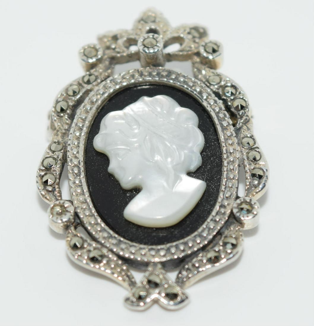 Vtg Sterling, Marcasite & Carved Mother of Pearl Cameo: This brooch is 1.37Â” long and .91Â” wide with marcasite stones surrounding a mother of pearl cameo. It is stamped and tested to be 925 sterling silver
