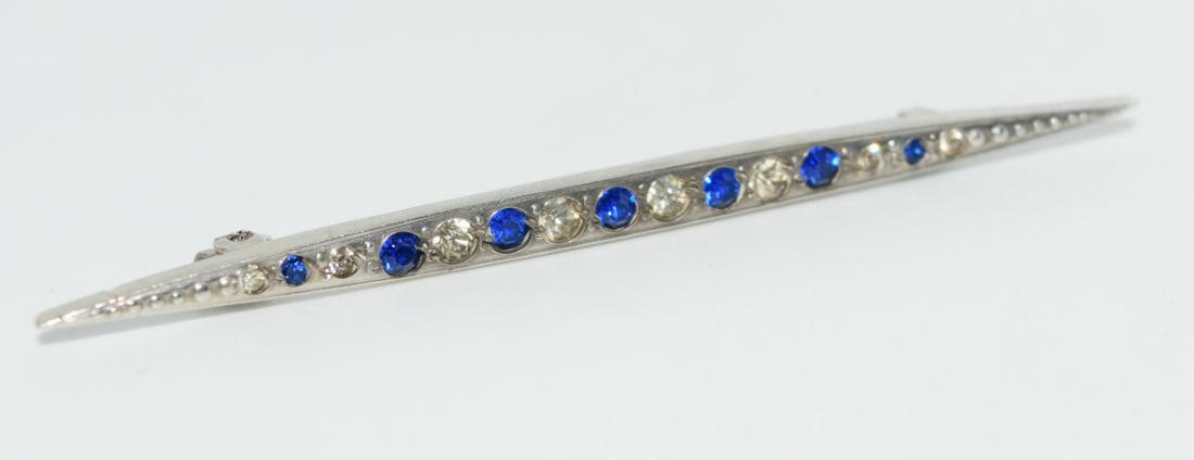 Vintage Sterling Silver Brooch: This brooch has unknown blue & clear stones. Most likely rhinestones or paste stones. It measures 60.5x3.7mm. Stamped sterling