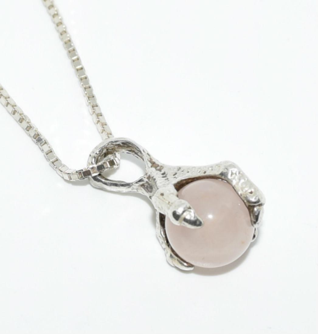 Sterling Silver Claw Holding Rose Quartz Necklace: Sterling silver claw pendant holding a rose quartz with a box chain necklace with a springring clasp. | Measurement: 19.5" length 1mm width, 23mm x 10mm pendant | Weight: 8.7 grams | Stamp: 925 on cha