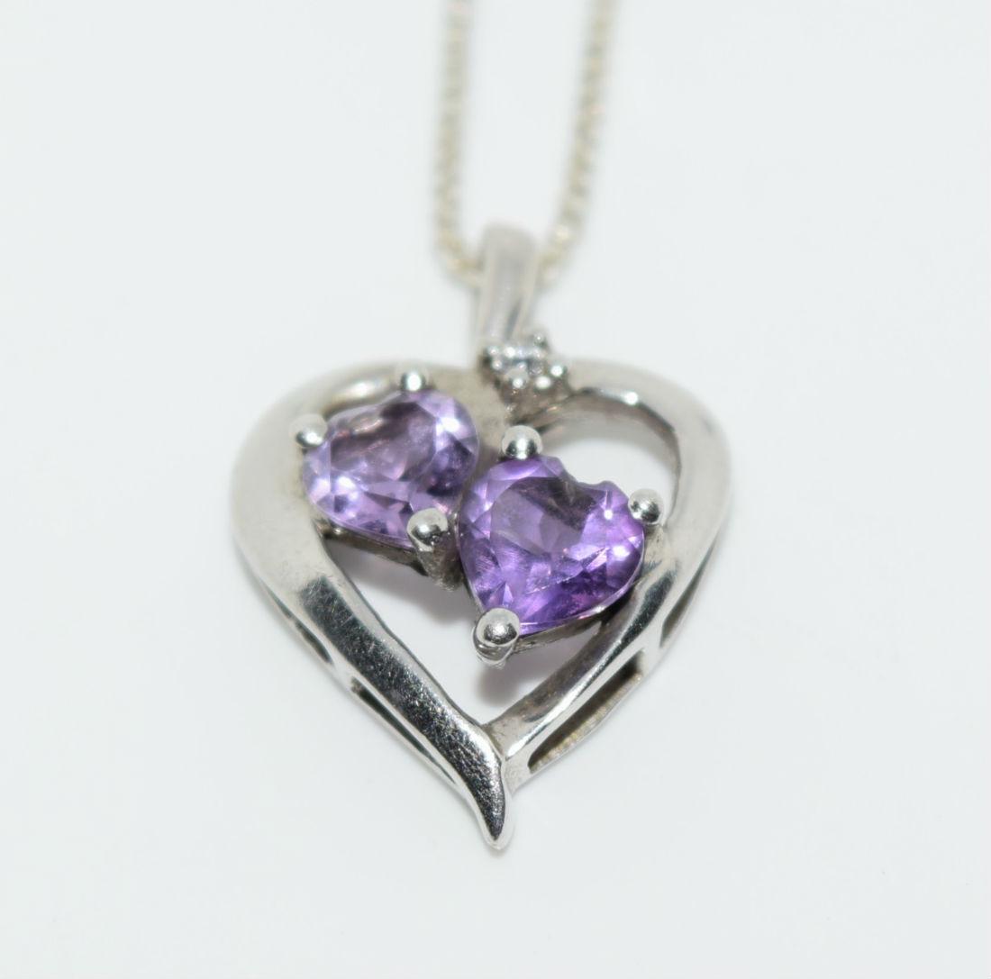 Sterling Silver Amethyst Heart Necklace: Sterling silver double amethyst cut heart and cubic zirconia heart pendant necklace | Measurement: 17.5" length, 0.7" x 0.5" pendant