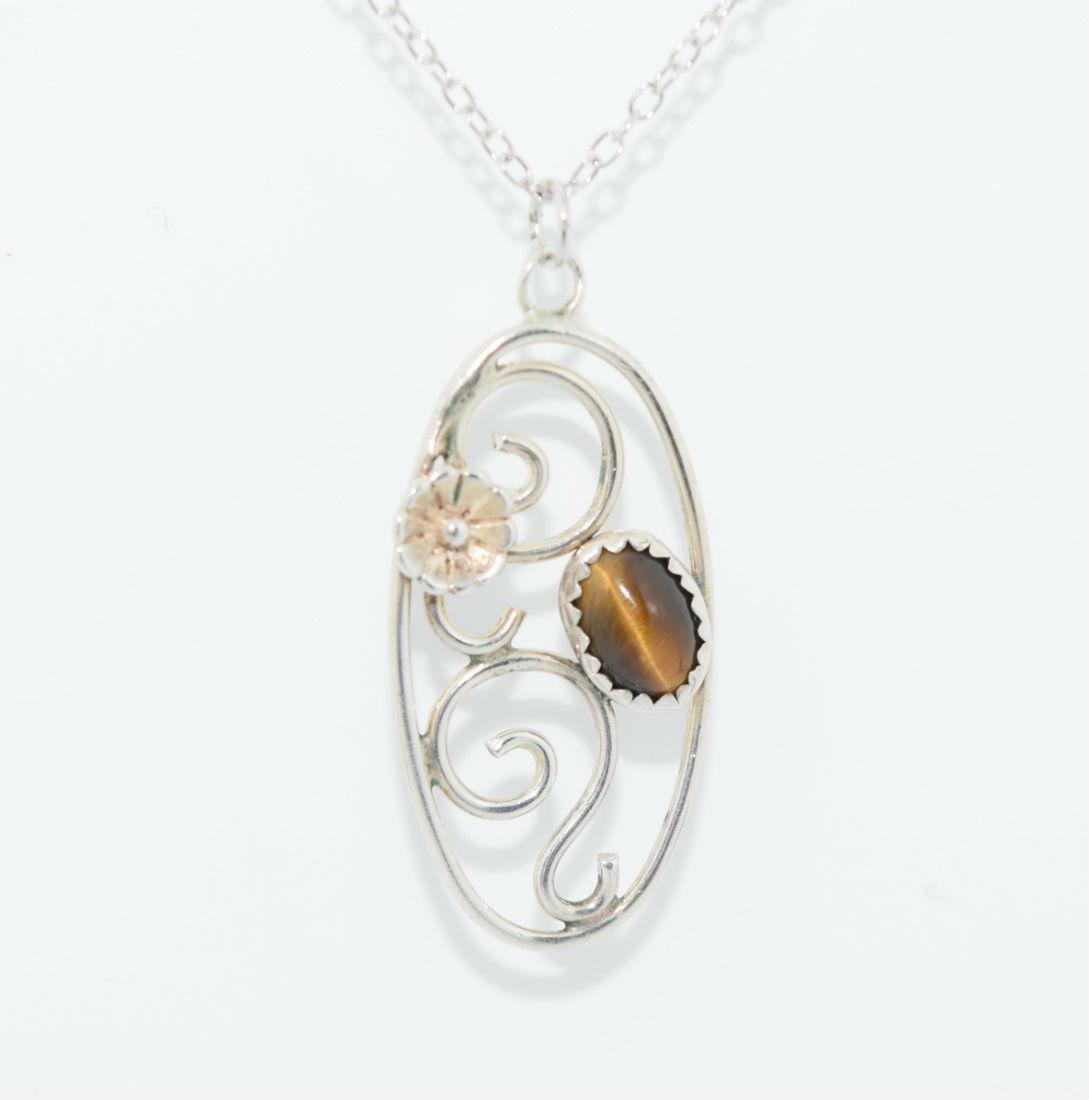 Sterling Silver Tiger's Eye Scrolled Necklace: Sterling silver tiger's eye & flower scrolled oval pendant necklace | Measurement: 18" length, 1.3" pendant drop 0.5" width