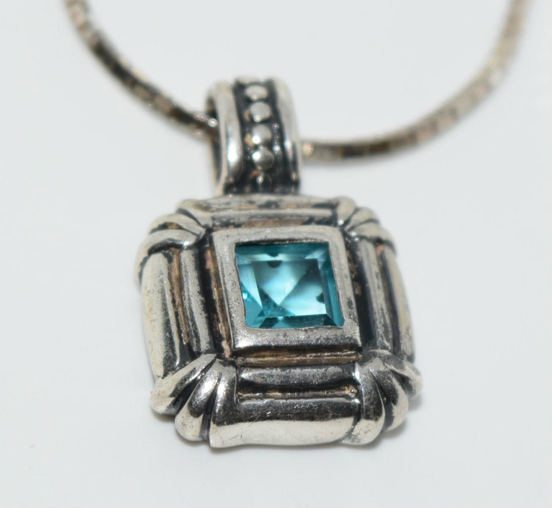 Vintage Sterling Aqua Blue Framed Necklace: 9.75 Gram Sterling Silver unknown blue stone pendant measures 14mm wide with a 21.4mm drop on a 1mm 30” chain