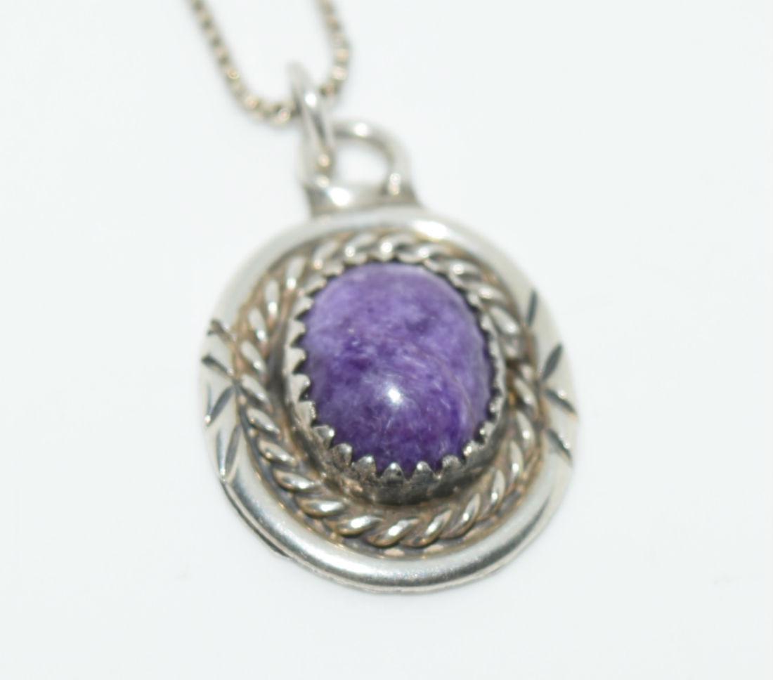 Sterling Silver Oval Purple Natural Stone Necklace: Sterling Silver pendant measures 15mm with a 24.5mm Drop with a purple stone on a .4mm 21.5Â” Box Chain