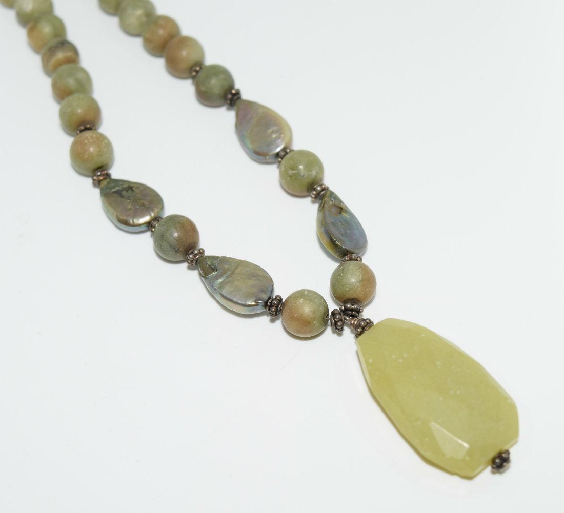 Natural green stone & abalone necklace: Natural green stone and abalone necklace with toggle clasp | Measurement: 17” length, 1.5” pendant drop