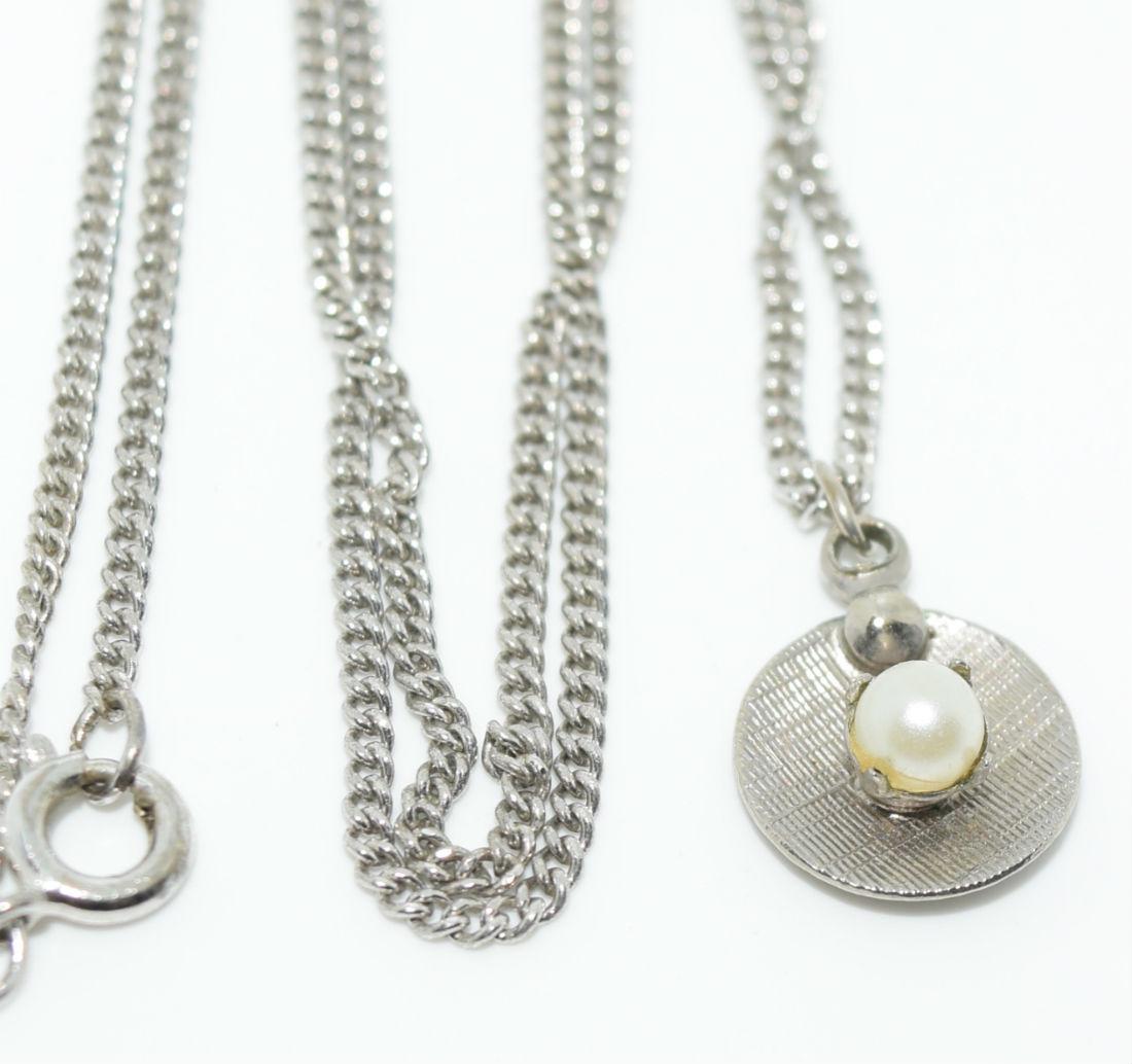 Vintage Sterling Silver Dainty Faux Pearl Necklace: Sterling Silver Pendant with a faux Pearl prong set Measures 10.5mm wide with a 15mm drop on a 17.5” Chain