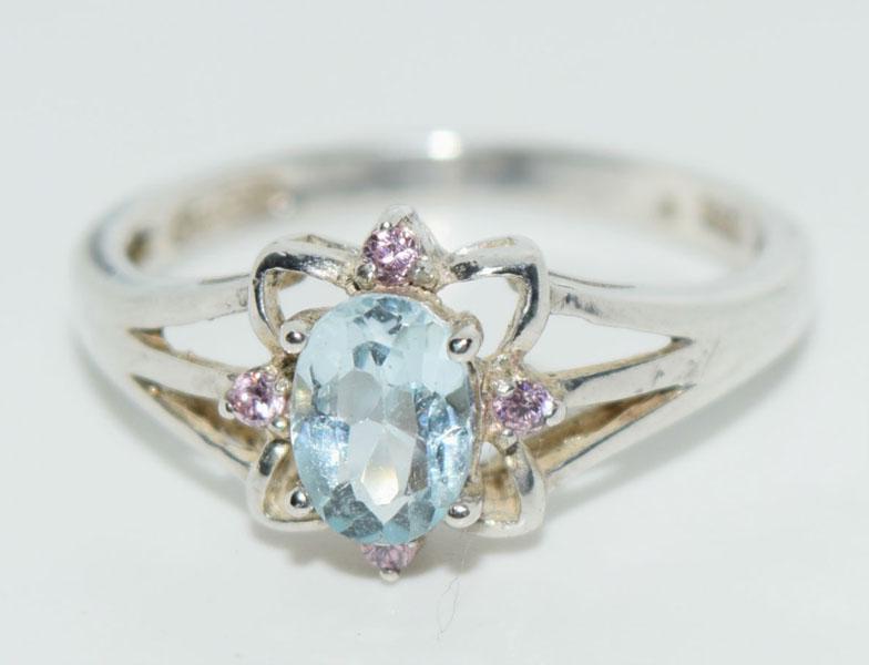 VTG Silver Avon Blue Topaz Ring: This Vintage Avon Sterling Silver Size 7.5 ring has a 5 x7mm Blue Oval Topaz and pink accent stones and measures 10.3mm at the widest.