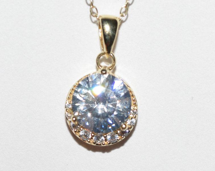 Gold over Silver Half Halo Necklace: This Gold over Sterling Silver Round Pendant measures 11mm wide with a 19.5mm drop. It has a 9mm round stone with a half halo on the bottom on a 20inch chain and is stamped ATI 925 China.