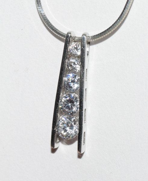 Sterling Silver Channel Set Necklace: This Sterling Silver Drop Channel Set Round Cz Stones Pendant measures 23 x 63mm on a 16inch snake chain.