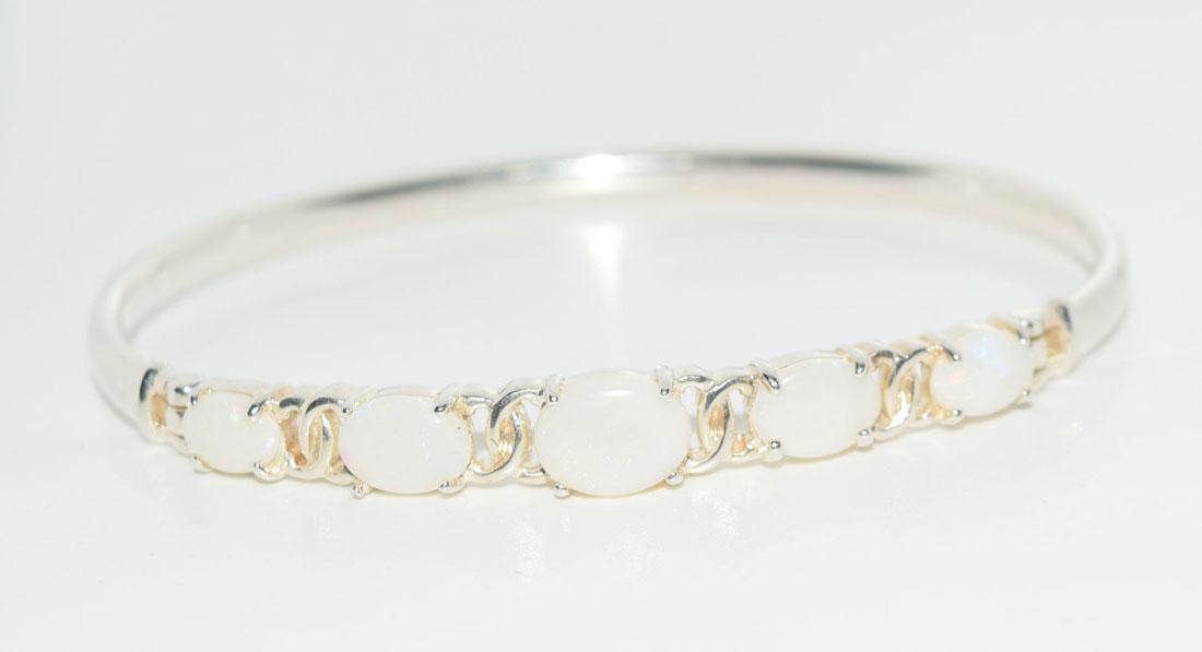 Sterling Silver Opal Bangle: This Bracelet is around 7inches long and has 7x9mm oval Opals.