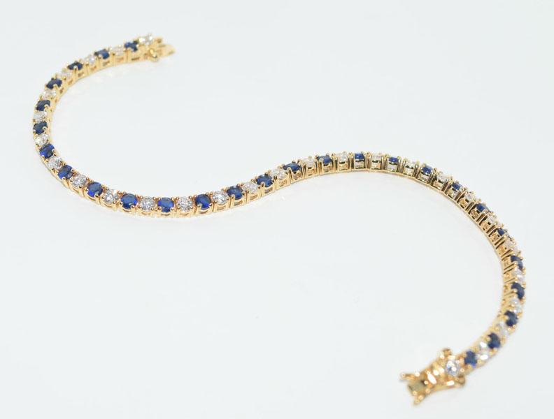 Gold Over Sterling Tennis Bracelet: This Gold over Silver tennis bracelet measures 3.5mm wide & 7.5inchs long with 3mm blue & white stones.