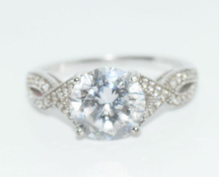 Sterling Silver Cross Over CZ Ring sz 8: This Sterling Silver 9mm Round Cz Size 8 Ring with a Cross Over Design is stamped YGI 925.