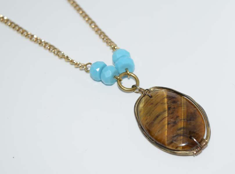 Express Gold Tone Tigers Eye Necklace: Designer Express gold tone tigers eye necklace with turquoise color beads | Measurement: 20” - 23” length, 47.8mm pendant drop, 32.6mm width