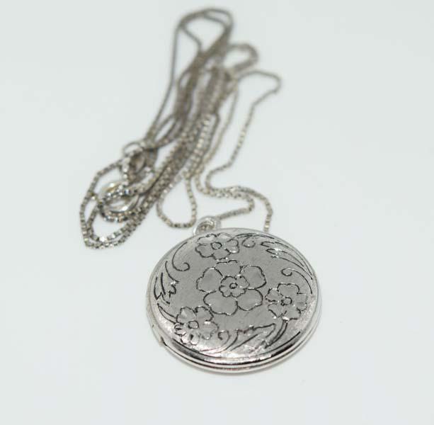 Silver Tone Etched Round Locket Necklace: This necklace measures 22.6mm round with a 28.4mm drop.