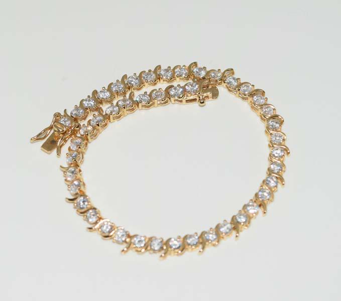 Gold over Sterling CZ Tennis Bracelet: This bracelet measures .4.mm wide 7inchs long weighs 8grams & stamped CZ 925.