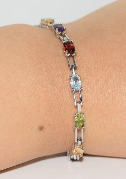 Sterling Gemstone Tennis Bracelet: Weighs 7.4grams Measures 4.5mm wide 7inches long Stamped 925 Tested Gemstones