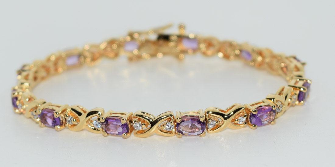 Gold over Sterling Amethyst Tennis Bracelet: Weighs 14.2grams Measures 5.2mm wide 7inches long Stamped 925 Tested Amethyst